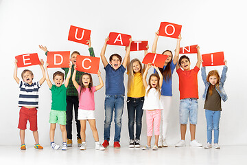 Image showing Education. Group of children with a red banners isolated in white