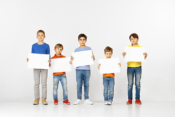 Image showing Group of children with a white banners isolated in white