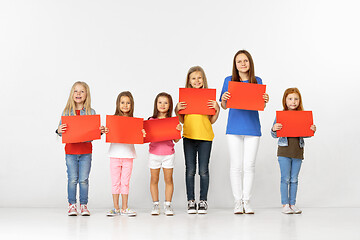 Image showing Group of children with red banners isolated in white