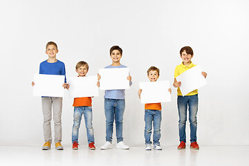 Image showing Group of children with a white banners isolated in white