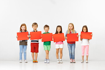 Image showing Group of children with red banners isolated in white