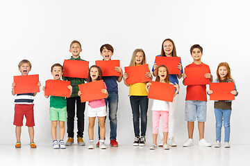 Image showing Group of children with a red banners isolated in white