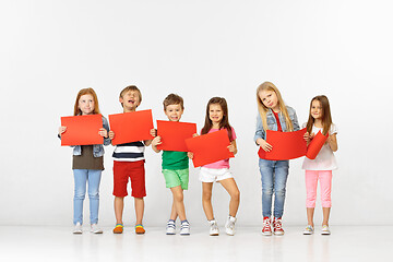 Image showing Group of children with red banners isolated in white