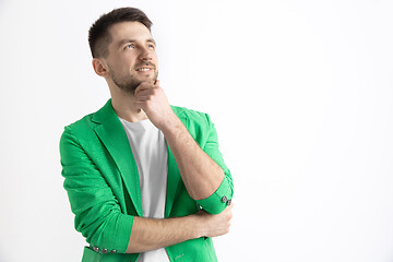 Image showing Young dreaming man isolated on white background looking at something