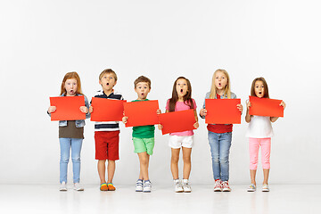 Image showing Group of children with red banners isolated in white