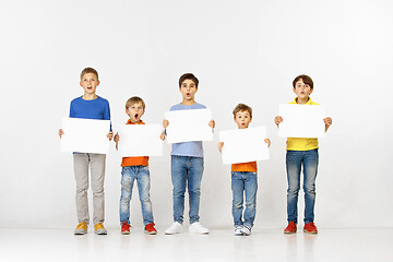 Image showing Group of children with a white banners isolated in white