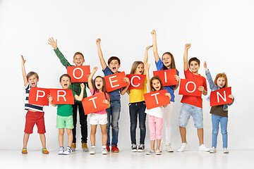 Image showing Protection. Group of children with a red banners isolated in white