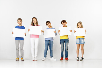 Image showing Group of children with a white banners isolated in white