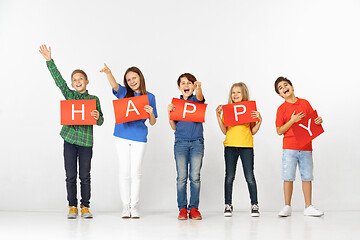 Image showing Happy. Group of children with red banners isolated in white