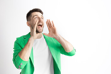 Image showing Young casual man shouting. Shout.