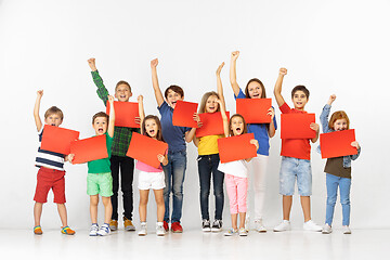 Image showing Group of children with a red banners isolated in white