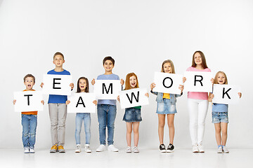Image showing Teamwork. Group of children with a banners isolated in white