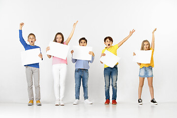Image showing Group of children with a white banners isolated in white