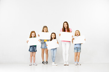 Image showing Group of children with a white banners isolated in white