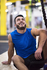 Image showing man relaxing before rope climbing