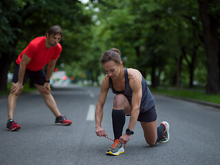 Image showing sporty woman tying running shoes laces