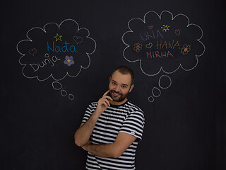 Image showing young future father thinking in front of black chalkboard