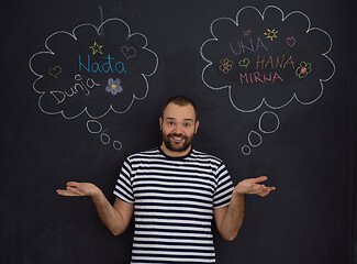 Image showing young future father thinking in front of black chalkboard
