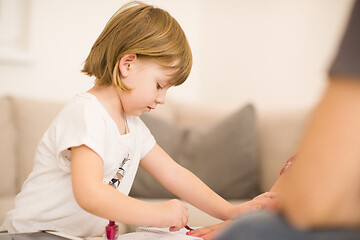 Image showing daughter painting nails to her pregnant mom