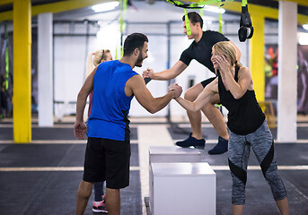 Image showing athletes working out  jumping on fit box