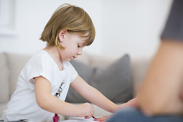 Image showing daughter painting nails to her pregnant mom