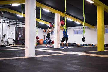 Image showing young athletes couple working out with medical ball