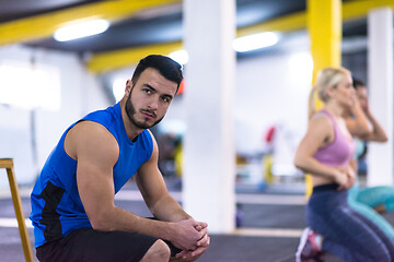 Image showing young athletes doing pushups with kettlebells