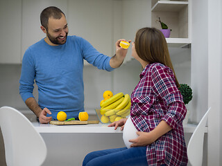 Image showing couple cooking food fruit lemon juice at kitchen