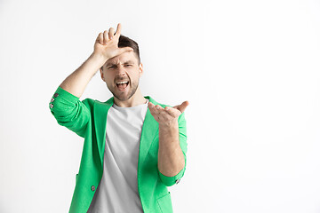 Image showing Losers go home. Portrait of happy guy showing loser sign over forehead