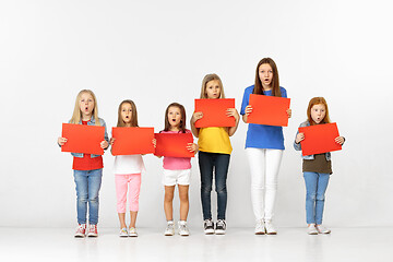 Image showing Group of children with red banners isolated in white