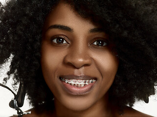 Image showing Portrait of a young black woman smiling with braces