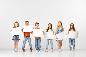 Image showing Group of children with a white banners isolated in white