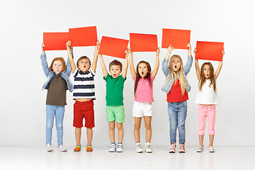 Image showing Group of children with red banners isolated in white