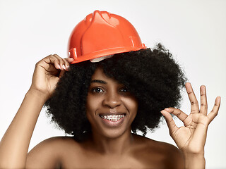 Image showing Portrait of confident female worker in orange helmet