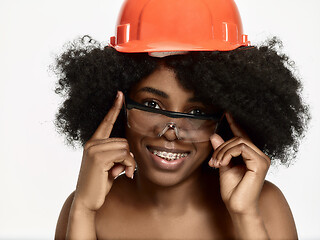 Image showing Portrait of confident female worker in orange helmet