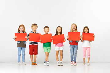 Image showing Group of children with red banners isolated in white