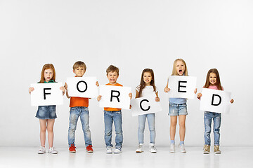 Image showing Forced. Group of children with a banners isolated in white