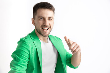 Image showing The happy businessman standing and smiling against gray background.