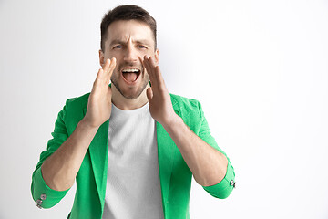 Image showing Young casual man shouting. Shout.