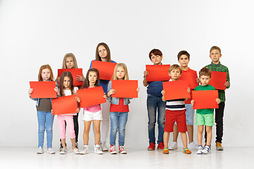 Image showing Group of children with red banners isolated in white