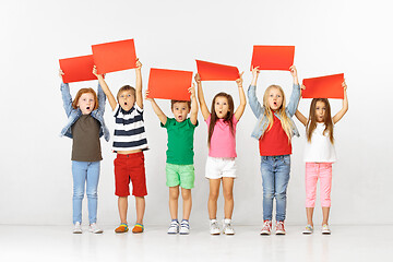 Image showing Group of children with red banners isolated in white