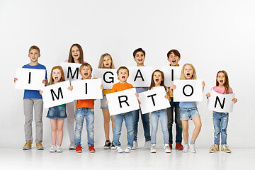 Image showing Immigration. Group of children with a banners isolated in white