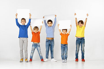 Image showing Group of children with a white banners isolated in white