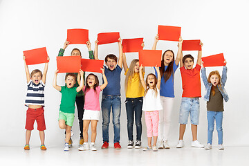 Image showing Group of children with a red banners isolated in white