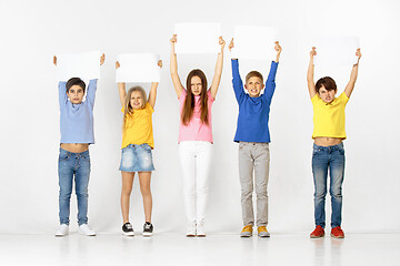 Image showing Group of children with a white banners isolated in white