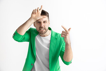 Image showing Losers go home. Portrait of happy guy showing loser sign over forehead