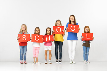 Image showing School. Group of children with red banners isolated in white