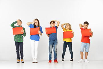 Image showing Group of children with red banners isolated in white