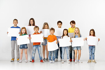 Image showing Group of children with a white banners isolated in white