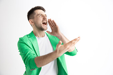 Image showing Young casual man shouting. Shout.